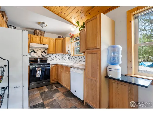 a kitchen with stainless steel appliances granite countertop a refrigerator and a stove