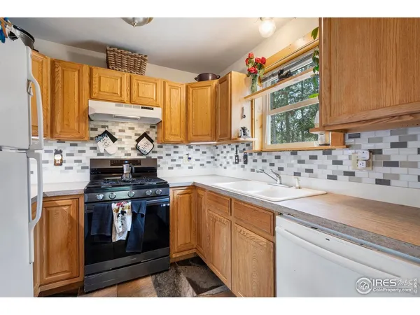 a kitchen with a stove a sink and a microwave
