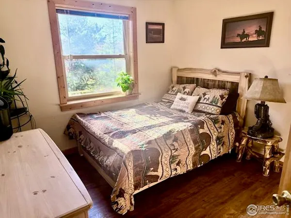 a bed sitting in a bedroom next to a window
