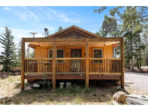 a view of a house with a wooden fence
