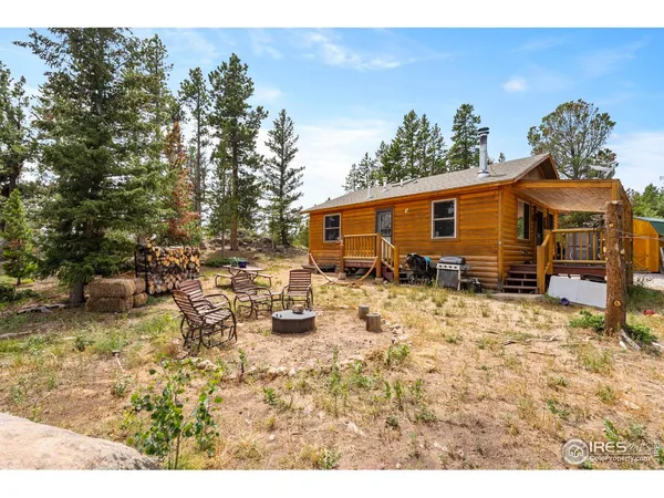 a backyard of a house with yard and outdoor seating