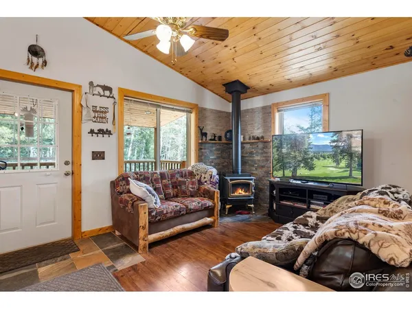 a living room with furniture tv and a large window
