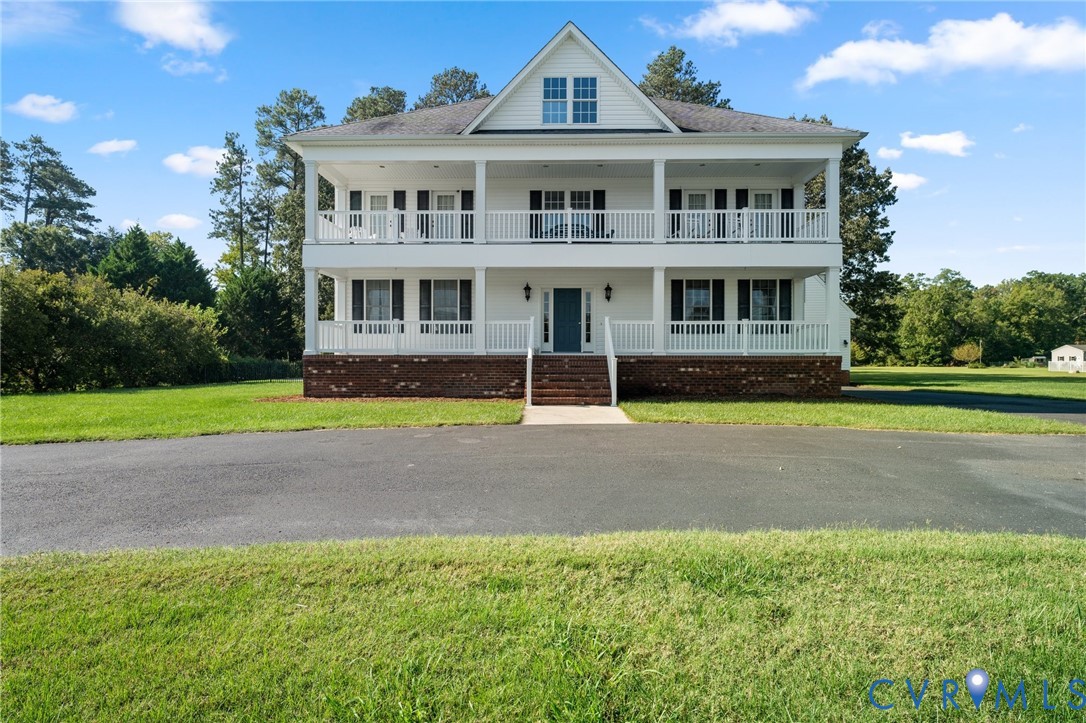 480 Rockingham Road Dunnsville, VA 22454 - Photo 1 of 41 a front view of a house with a yard