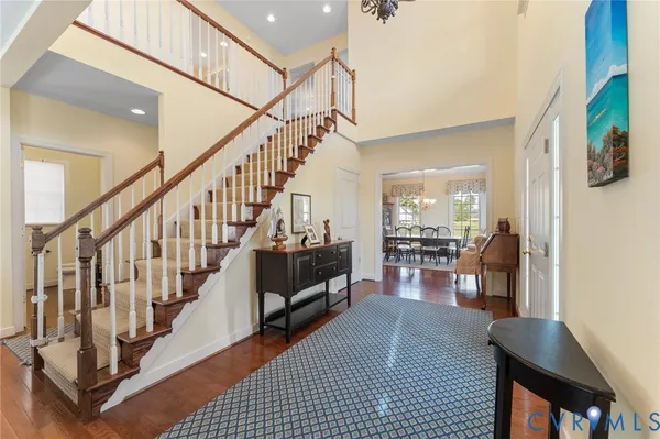 a view of entryway and hall with wooden floor