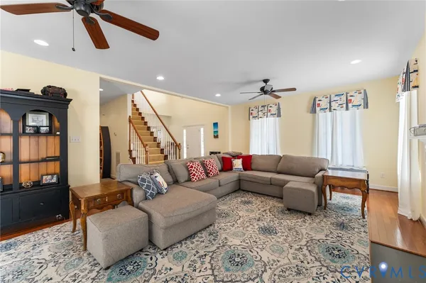 a living room with furniture and wooden floor