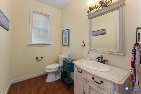 a bathroom with a sink toilet and a mirror
