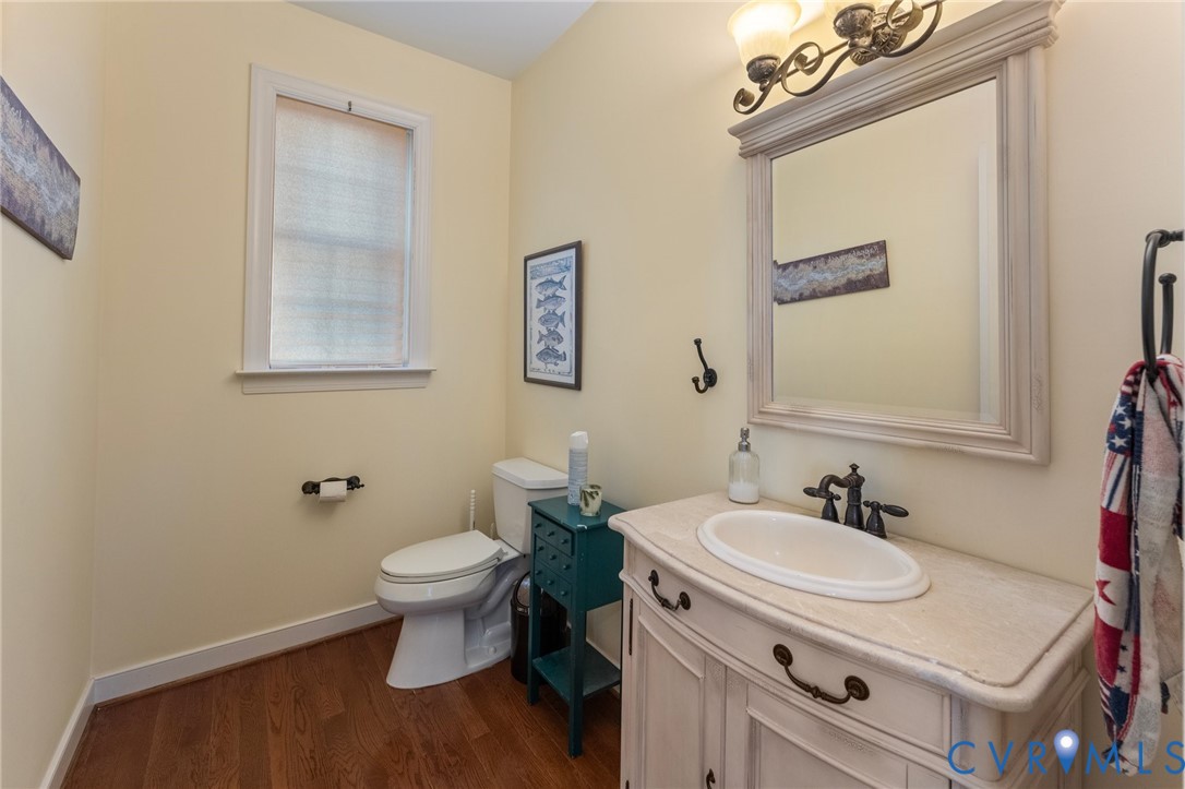 480 Rockingham Road Dunnsville, VA 22454 - Photo 19 of 41 a bathroom with a sink toilet and a mirror