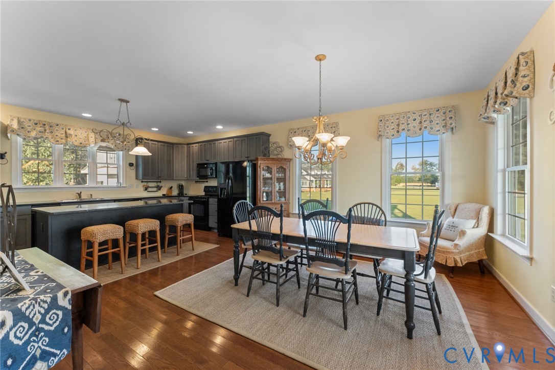480 Rockingham Road Dunnsville, VA 22454 - Photo 22 of 41 a view of a dining room with furniture window and wooden floor