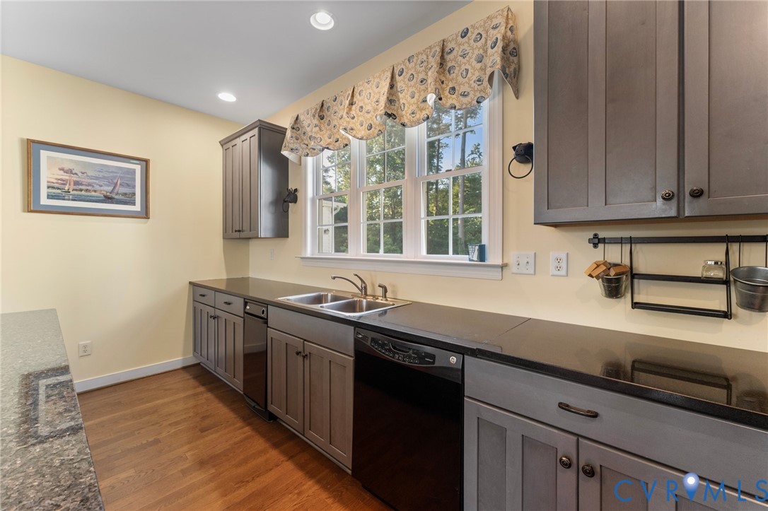 480 Rockingham Road Dunnsville, VA 22454 - Photo 23 of 41 a kitchen with a sink and cabinets
