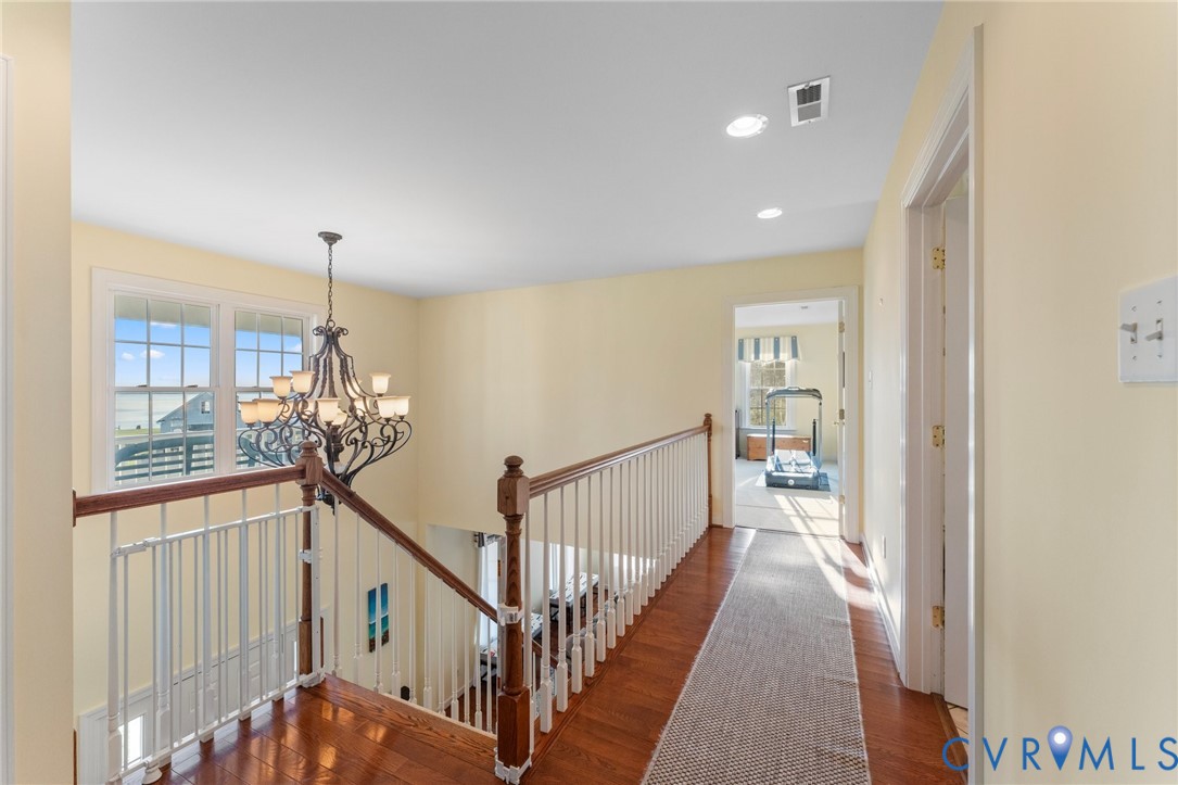 480 Rockingham Road Dunnsville, VA 22454 - Photo 24 of 41 a view of a hallway with wooden floor and staircase