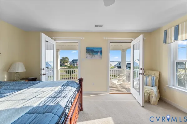 a bedroom with a bed and a large window