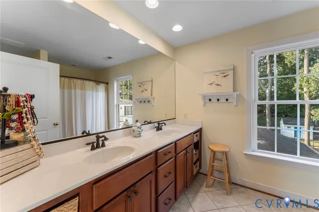 a bathroom with a sink double vanity and a tub