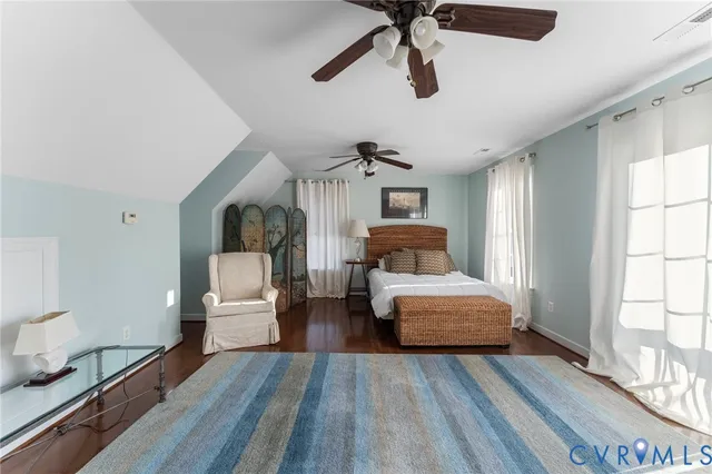 a bedroom with furniture and wooden floor