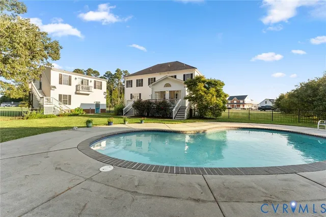 a view of a swimming pool and a yard