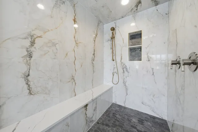 a bathroom with a bathtub and shower