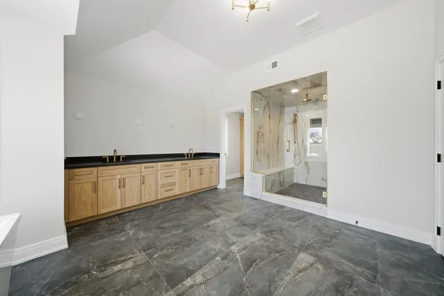 a view of a kitchen with white cabinets