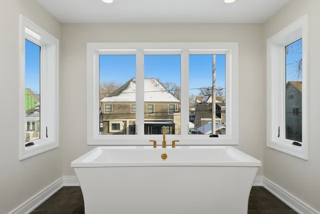 a view of kitchen with a sink and mirror