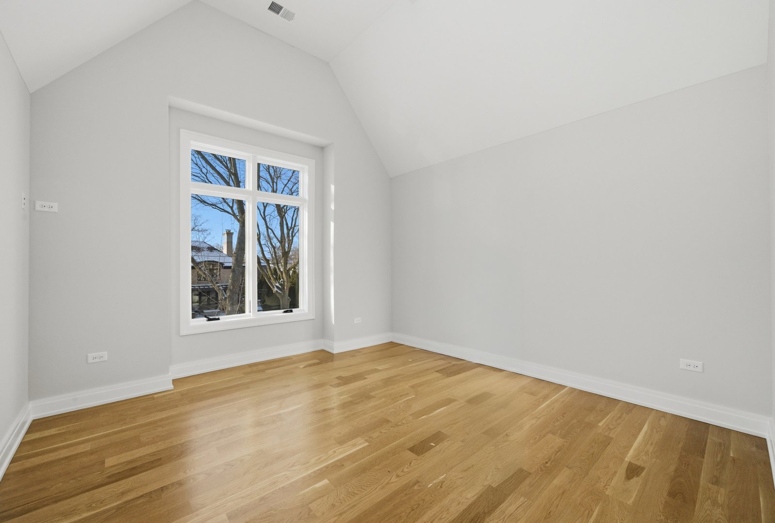 611 South Prospect Avenue Elmhurst, IL 60126 - Photo 21 of 28 a view of an empty room with wooden floor and a window