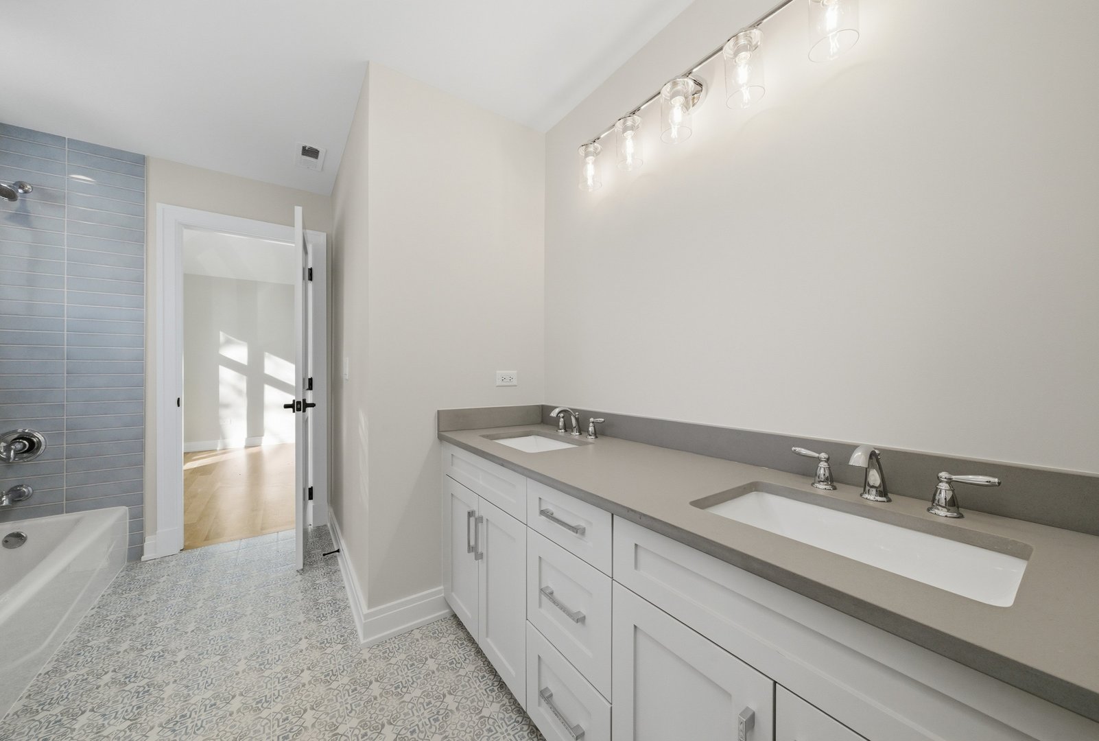 611 South Prospect Avenue Elmhurst, IL 60126 - Photo 24 of 28 a spacious bathroom with a granite countertop sink and a mirror