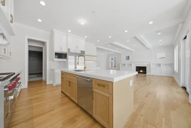 a large kitchen with a large counter top appliances and cabinets