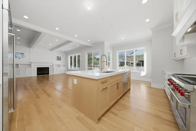 a large kitchen with stainless steel appliances granite countertop a stove and a sink