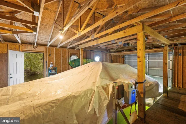 a view of a big house with large trees and plants
