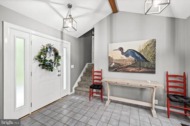 a bedroom with a bed couch and windows