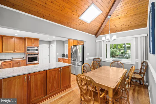 a bathroom with a sink vanity granite shower and a mirror
