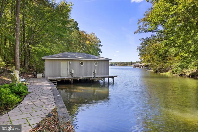 a view of a house with a yard from a lake view