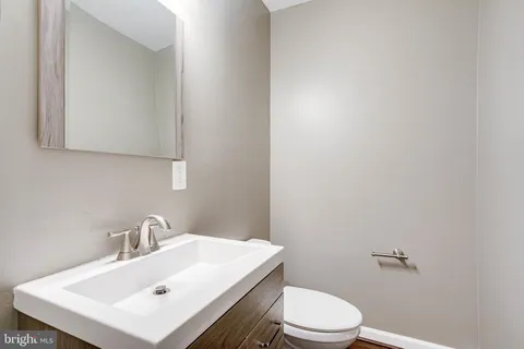 a bathroom with a sink vanity and a mirror