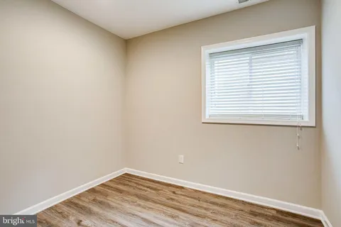 a view of a room with wooden floor