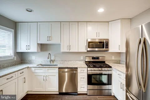 a view of a kitchen from a hallway
