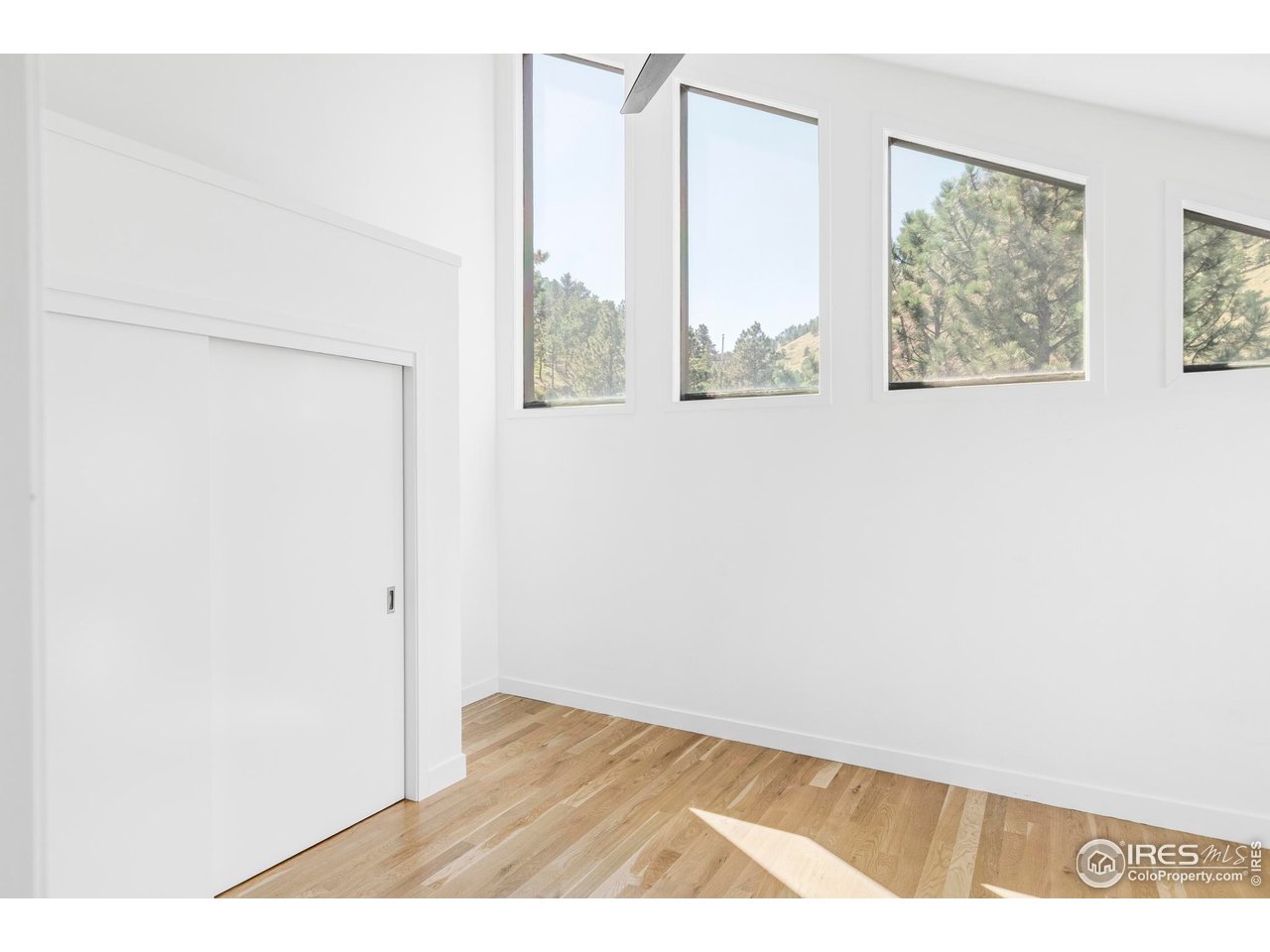 71 Ridge Drive Boulder, CO 80304 - Photo 24 of 42 a view of an empty room with wooden floor and a window