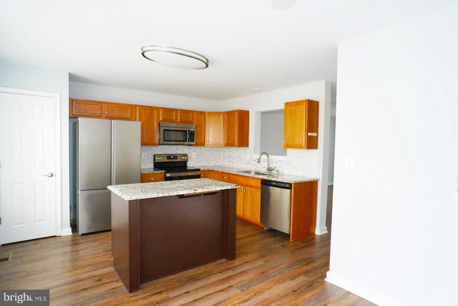 1217 Steed Street Ranson, WV 25438 - Photo 7 of 23 a kitchen with stainless steel appliances granite countertop a sink stove and refrigerator