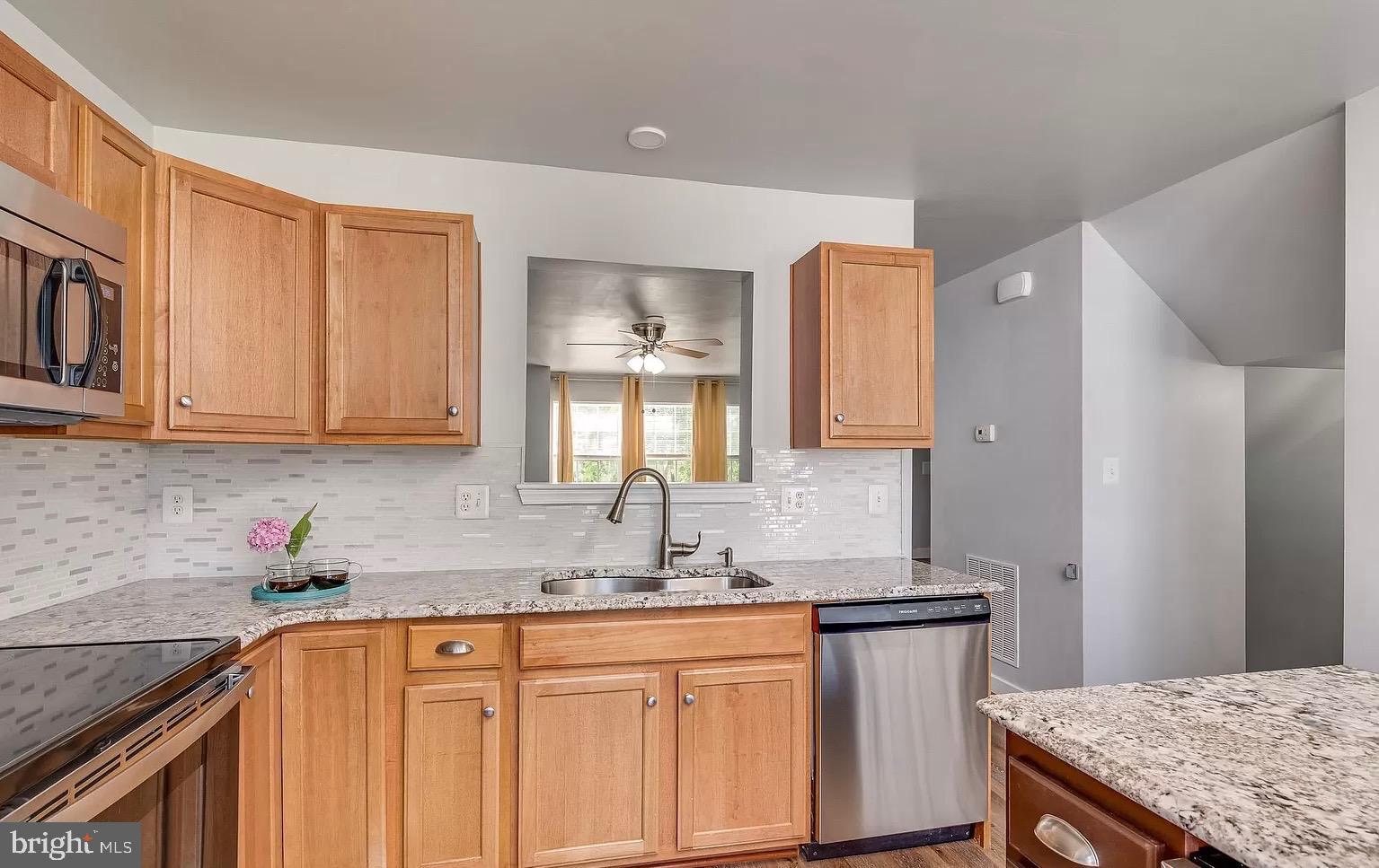 1217 Steed Street Ranson, WV 25438 - Photo 9 of 23 a kitchen with stainless steel appliances granite countertop a sink stove and cabinets
