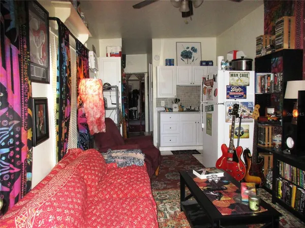 a living room filled with furniture and a book shelf