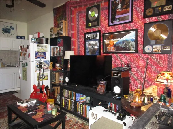 a living room filled with furniture and a flat screen tv