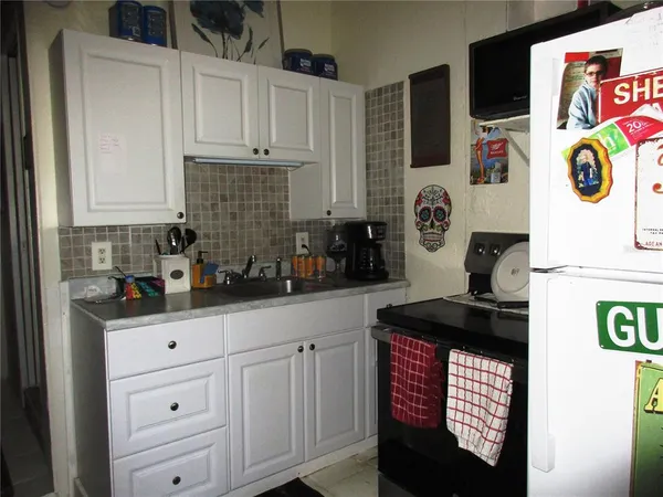 a kitchen with stainless steel appliances and cabinets
