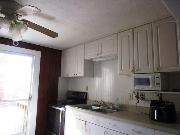 a kitchen with granite countertop a stove and a refrigerator