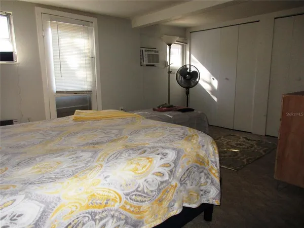 a bedroom with a bed and a window