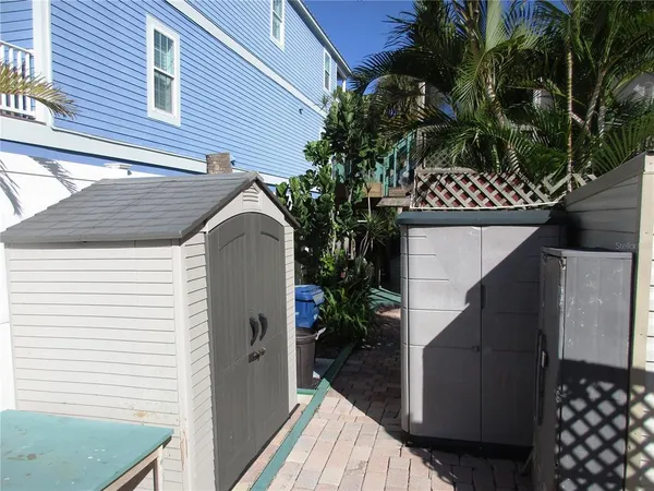 a view of a yard with plants and trees