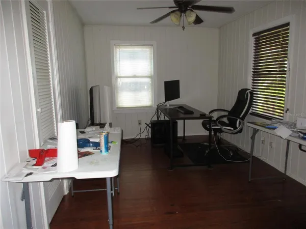 a view of a workspace with furniture and a window