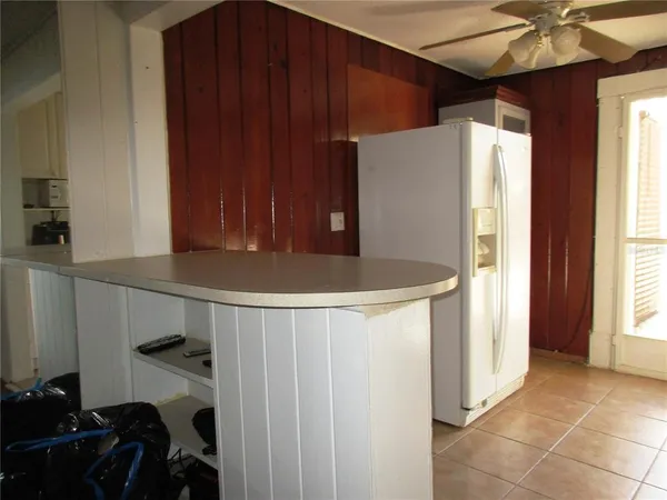 a refrigerator freezer sitting inside of a kitchen