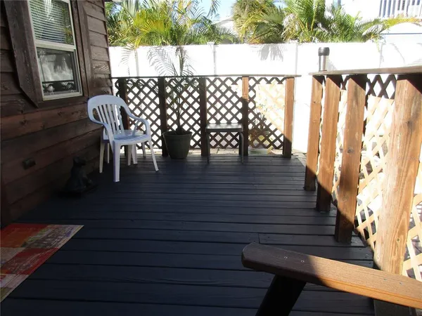 a view of outdoor seating and deck in the backyard