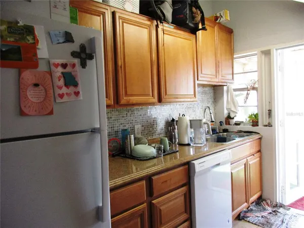 a kitchen with a refrigerator and a sink