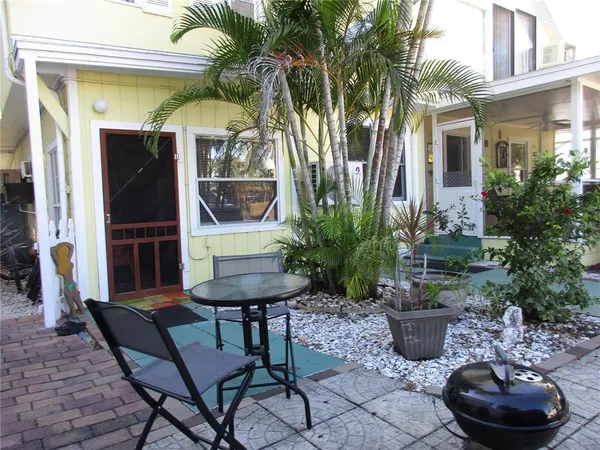 a view of a house with backyard and sitting area