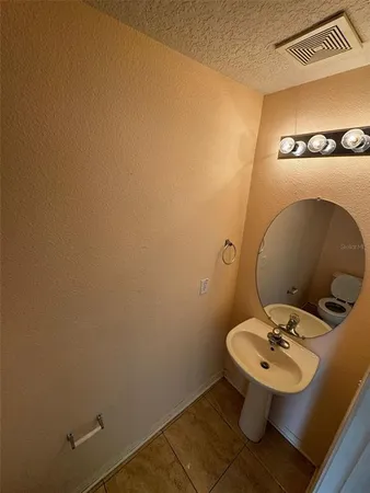 a bathroom with a sink and mirror