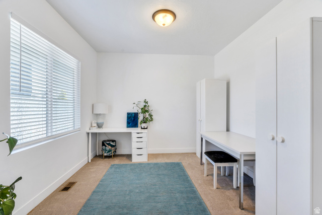 646 South Meade Street Mapleton, UT 84664 - Photo 10 of 46 Bright room featuring a wide window with horizontal blinds, neutral carpet flooring, and a ceiling-mounted light fixture