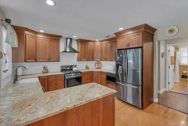 a kitchen with stainless steel appliances granite countertop a refrigerator stove and sink