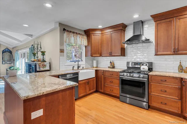 a kitchen with stainless steel appliances granite countertop a stove sink and cabinets
